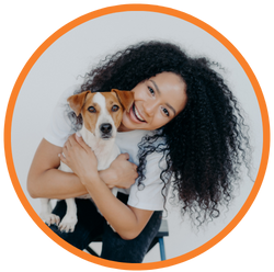woman holding a dog smiling