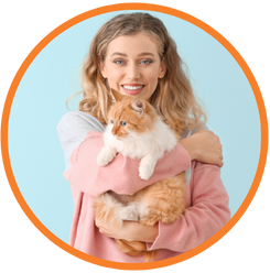 woman smiling holding orange and white cat
